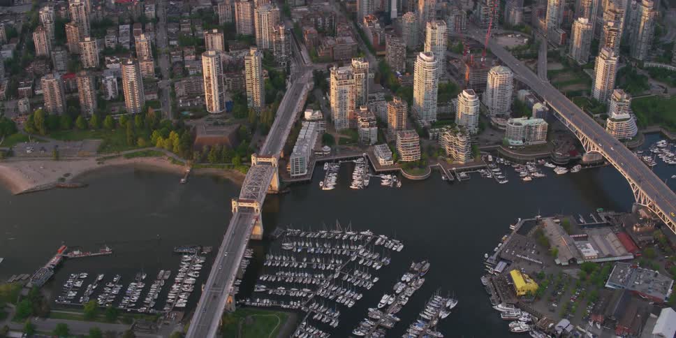 Marinas nestle near bridges crossing river to downtown