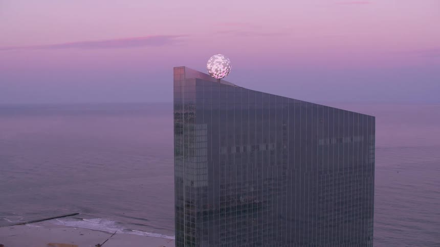 Aerial view of a city near the ocean coast at dusk