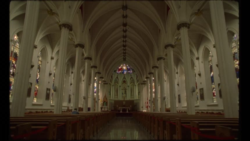 Pews and stained glass inside a church