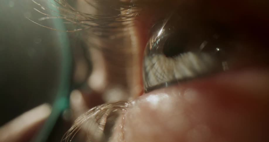 Person wearing glasses opens their eye