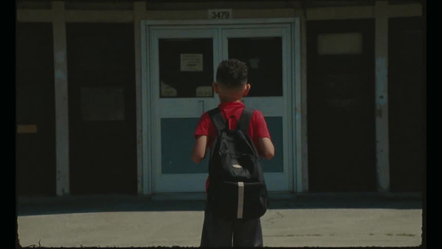 A child walks towards the school