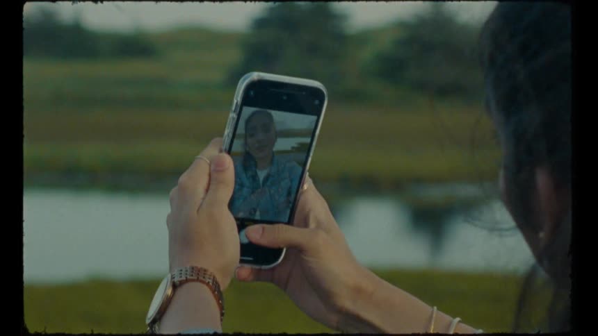 Woman standing near river takes selfie
