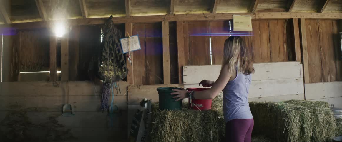 A girl taps a pot with a spoon