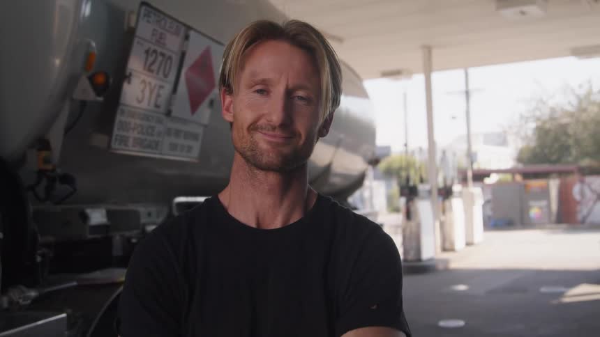 A portrait of a man standing outdoors