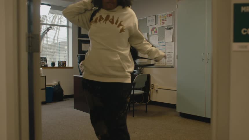 School career counselor waves as student leaves and then shakes his head