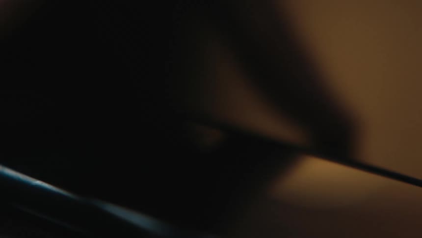 Person sets smartphone down in dimly lit room