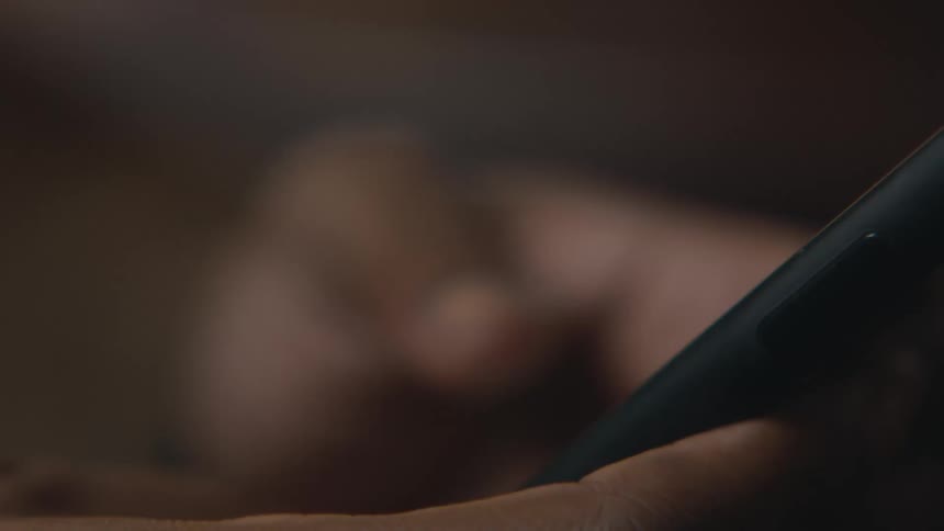 A person uses their thumbs to quickly type a message on their smart phone