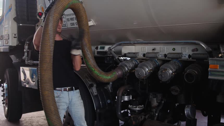 A man fills the gas station from his truck