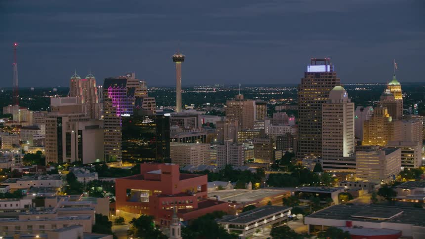 Aerial view of a downtown city at night is displayed