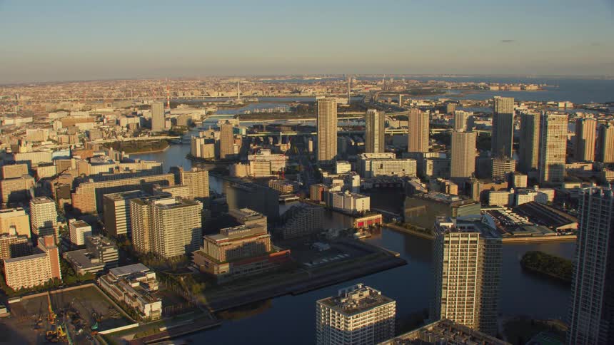 An aerial view of high rise offices and apartments in a city with a river running through it