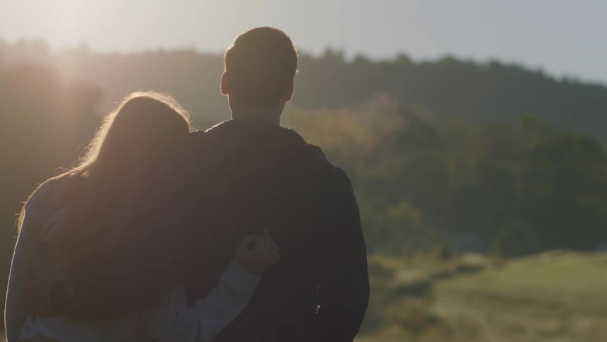 A man and woman enjoying a sunny morning outside