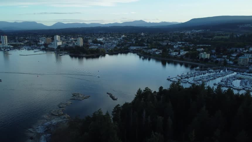 A boat leaves a wake as it travels toward the marina at nanaimo harbor on vancouver island