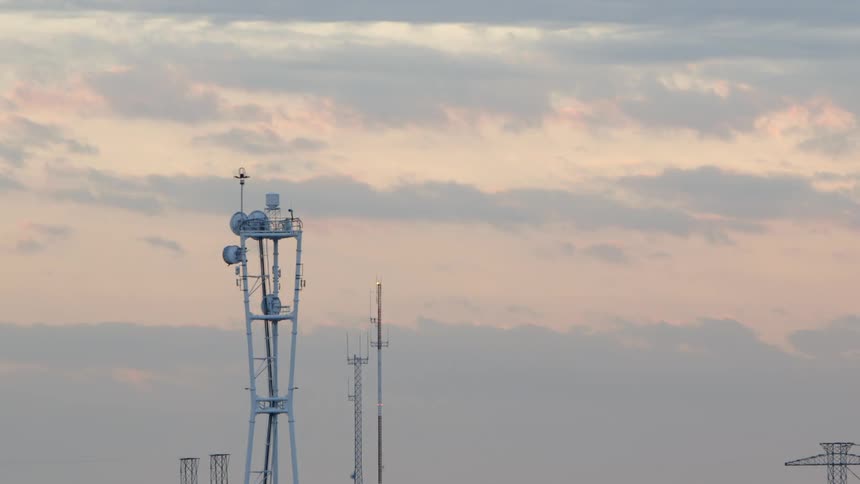 A cloudy skyline with antennas