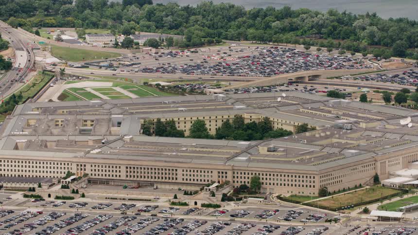 Cars travel on highways past the pentagon building