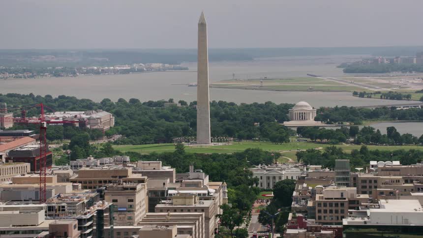 Buildings around the washington monument in the national mall in washington dc and the capitol building is in the distance