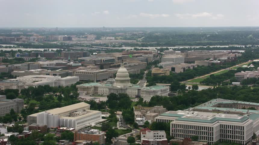 A domed government building in a metropolis during the day