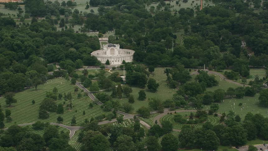 A massive white castle sits surrounded by forests and cemeteries