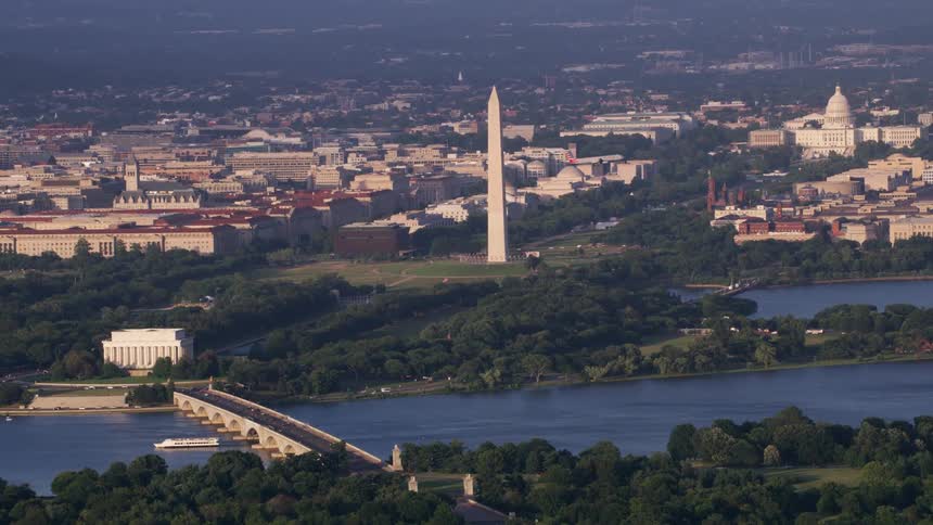 A passenger plane flies over a bridge in the us capitol