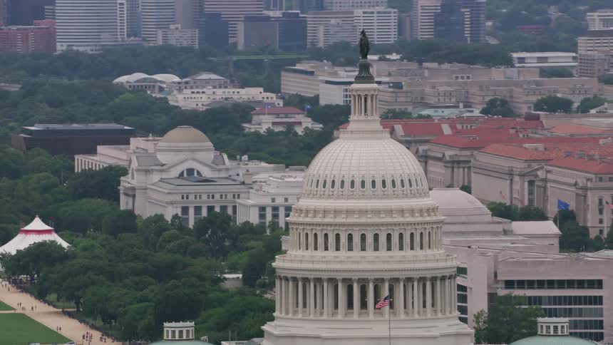 A statue sits atop a dome on a us government building