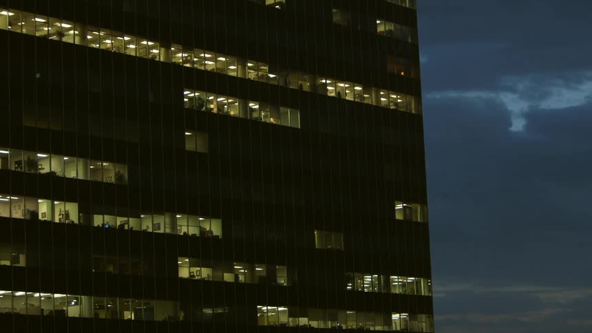 The side of a building has many lit windows