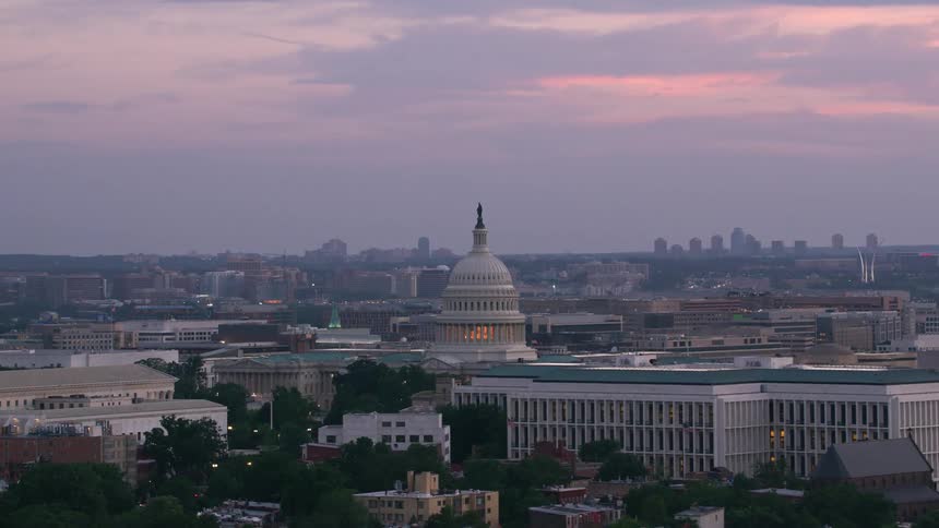 A state capital building sits across the horizon from downtown