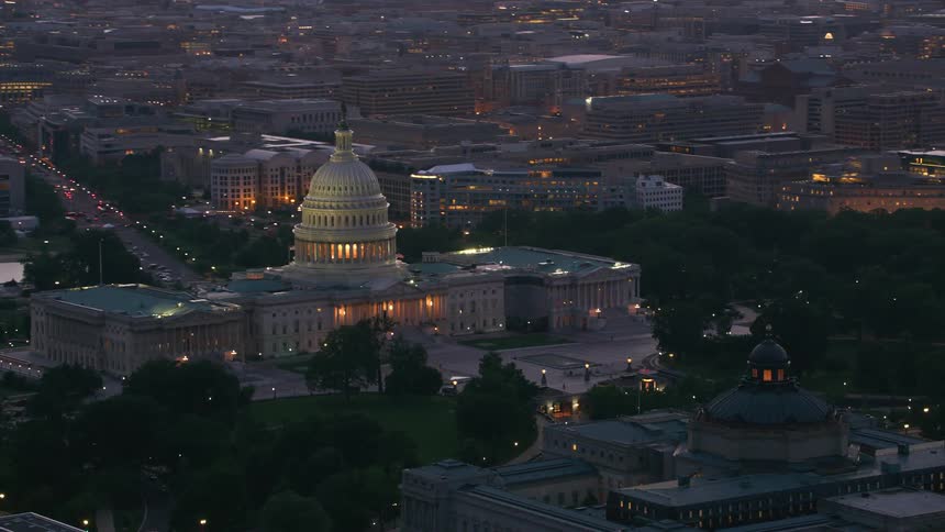 Aerial view of a downtown city during dusk is displayed