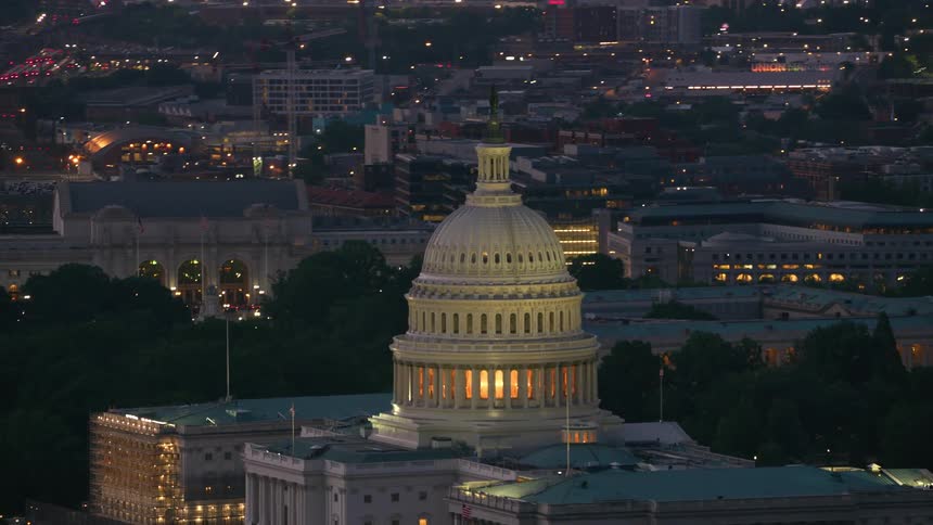 The united states capitol building glowing at night