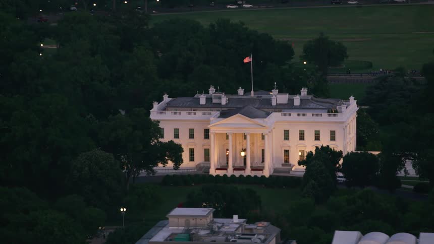 The american flag flying high above the white house