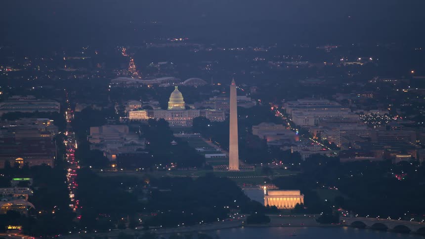 Aerial view of a downtown city at night time is displayed