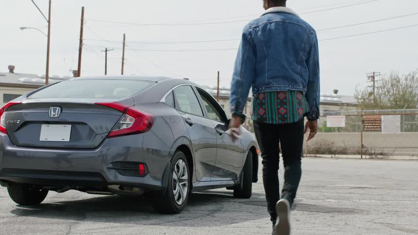 Couple walking towards a parked car in a parking lot