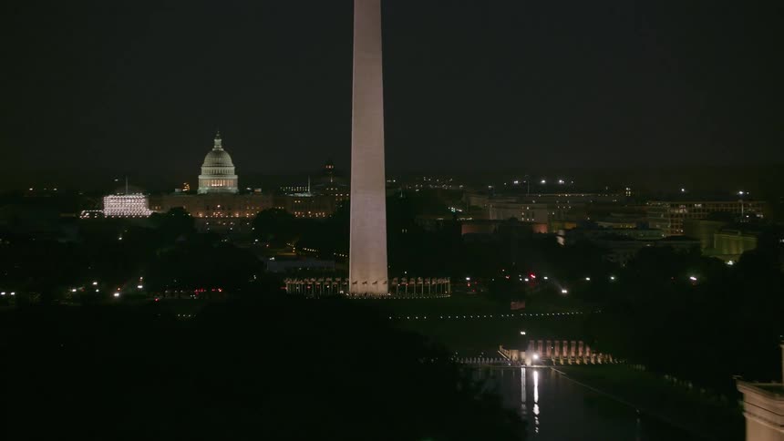 Aerial view of tall towers in a city is displayed at night