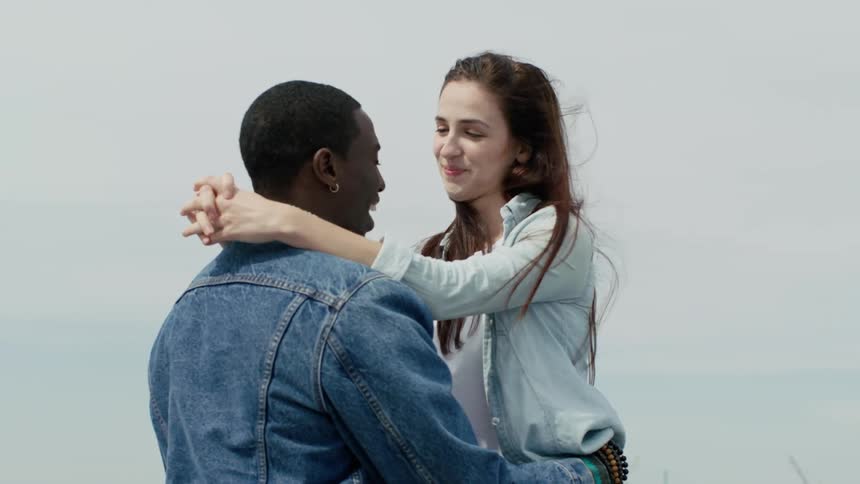 A girl hugs a man