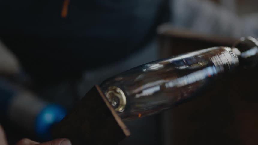 Glass is being spun into a bottle