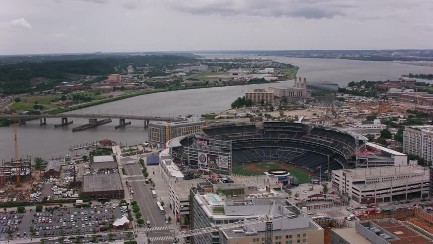 Aerial view of a stadium in a downtown city is displayed