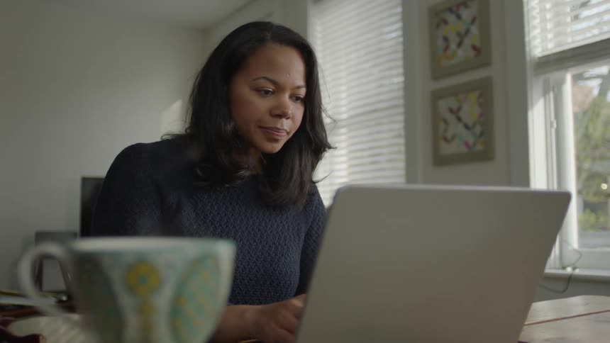 A woman working in her home office on laptop