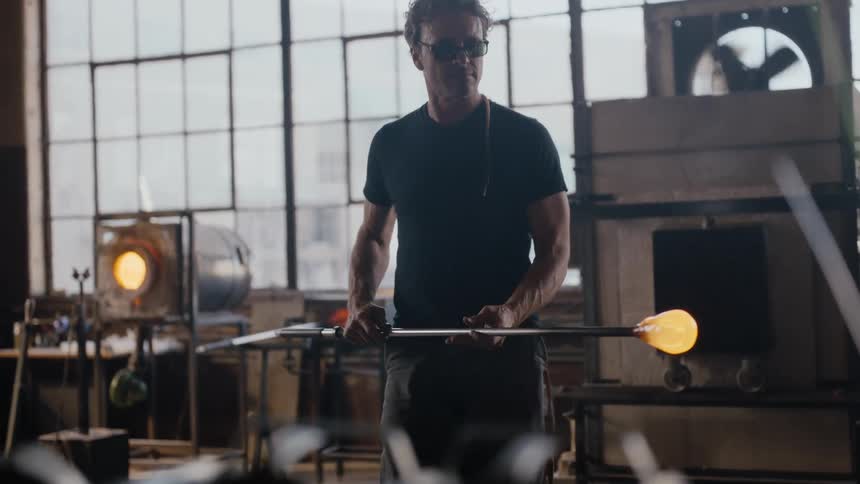 A glass blower working in his shop