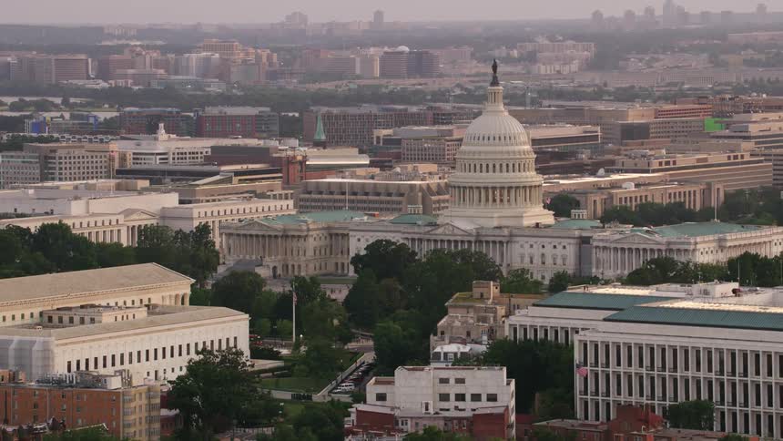 Aerial view of a government building in a downtown city is displayed