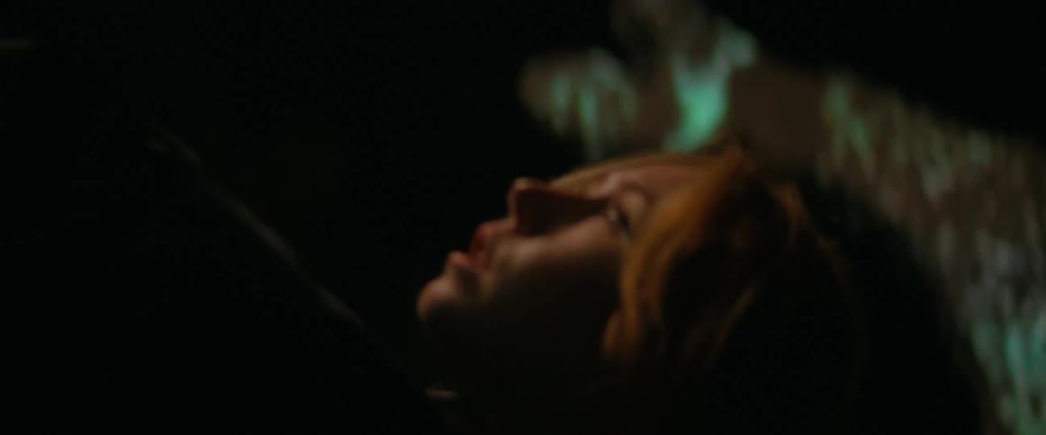 A woman is walking outdoors during the night