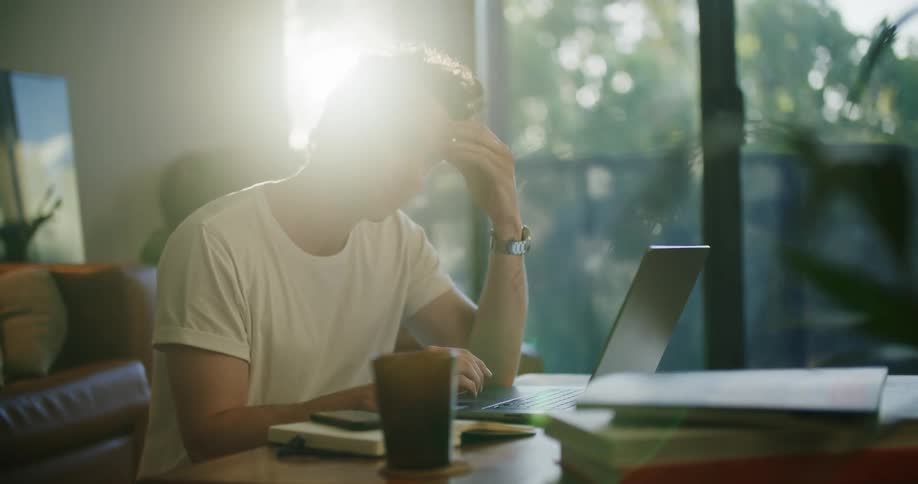 A man uses his laptop then closes it