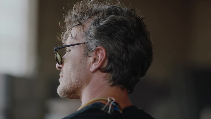 A handsome artist with glasses working in his art studio
