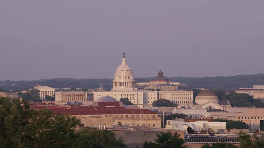 A domed government building in a city during the day