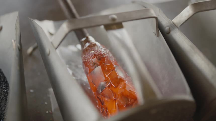 Heated glass on a rod turned to pick up additional shards
