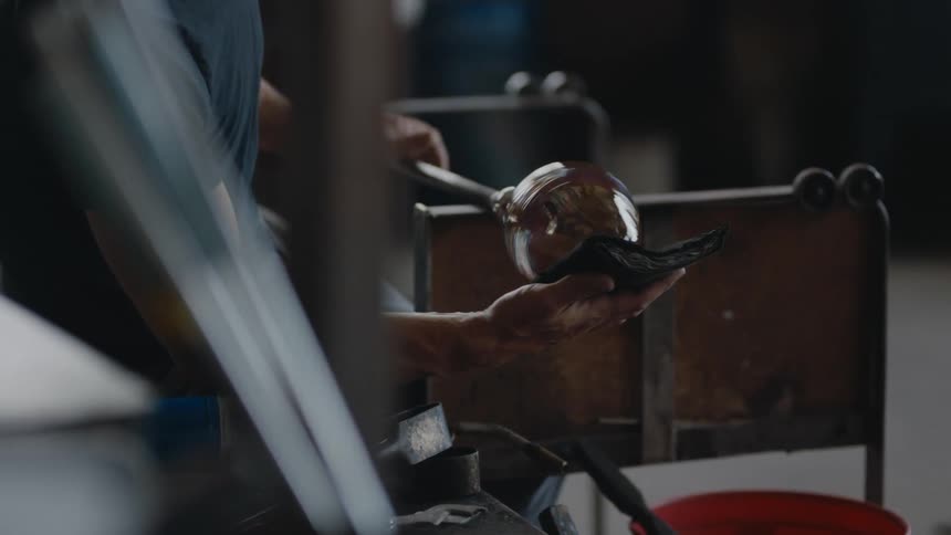A glass blower shaping glass