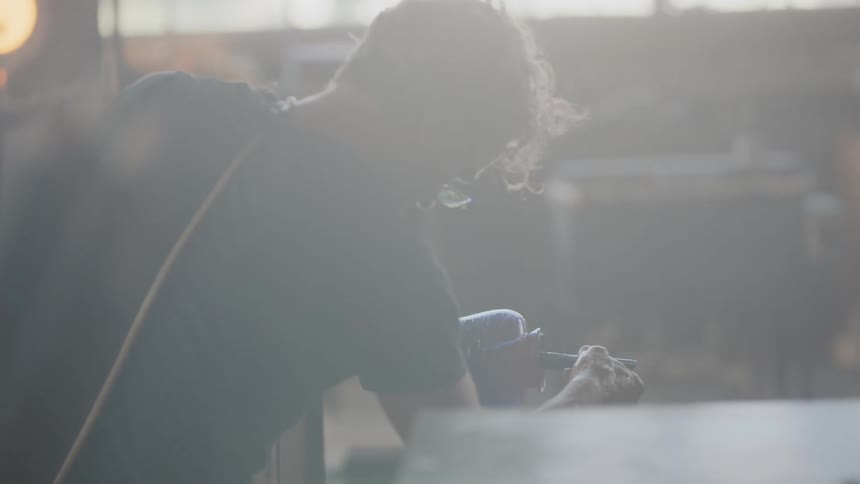 Backlit shot of artist working in his studio