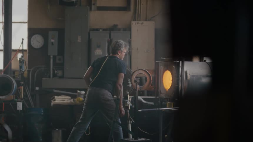 Artist walking through industrial production facility
