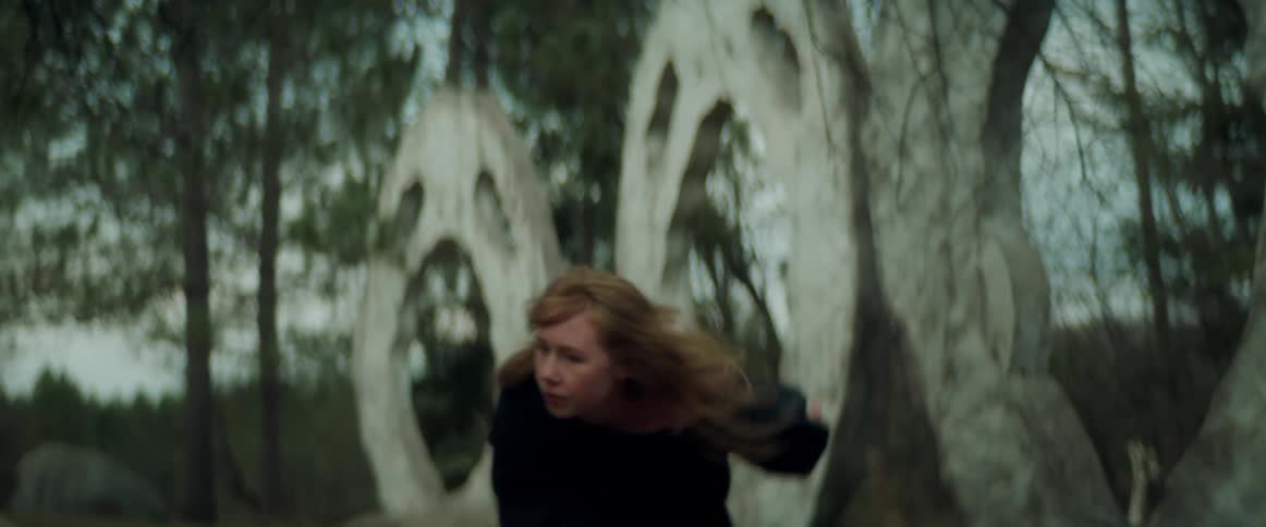 A woman dances outdoors during the day