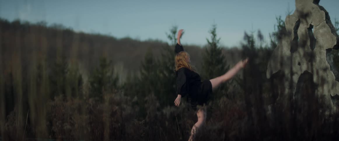 Woman is dancing in the woods during the spring time