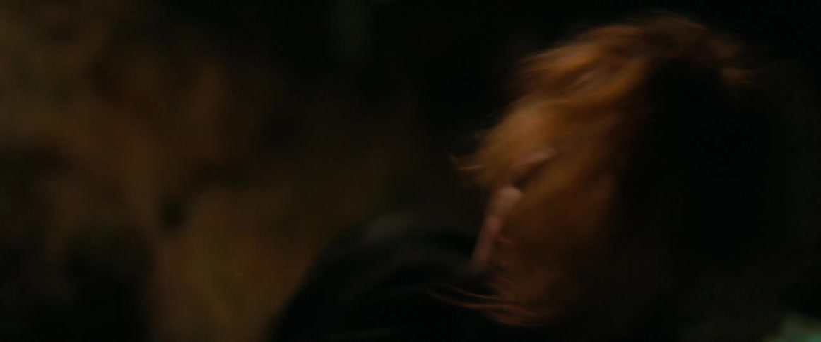 A woman is dancing around at night