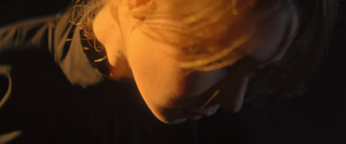Close up of a teenage girls face as she dances outside