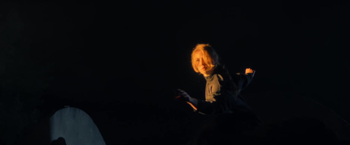 Woman is dancing outdoors during the night time